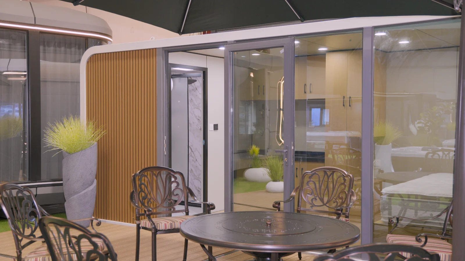 Granny flat with sliding glass doors, timber slat cladding and a fitted kitchen inside
