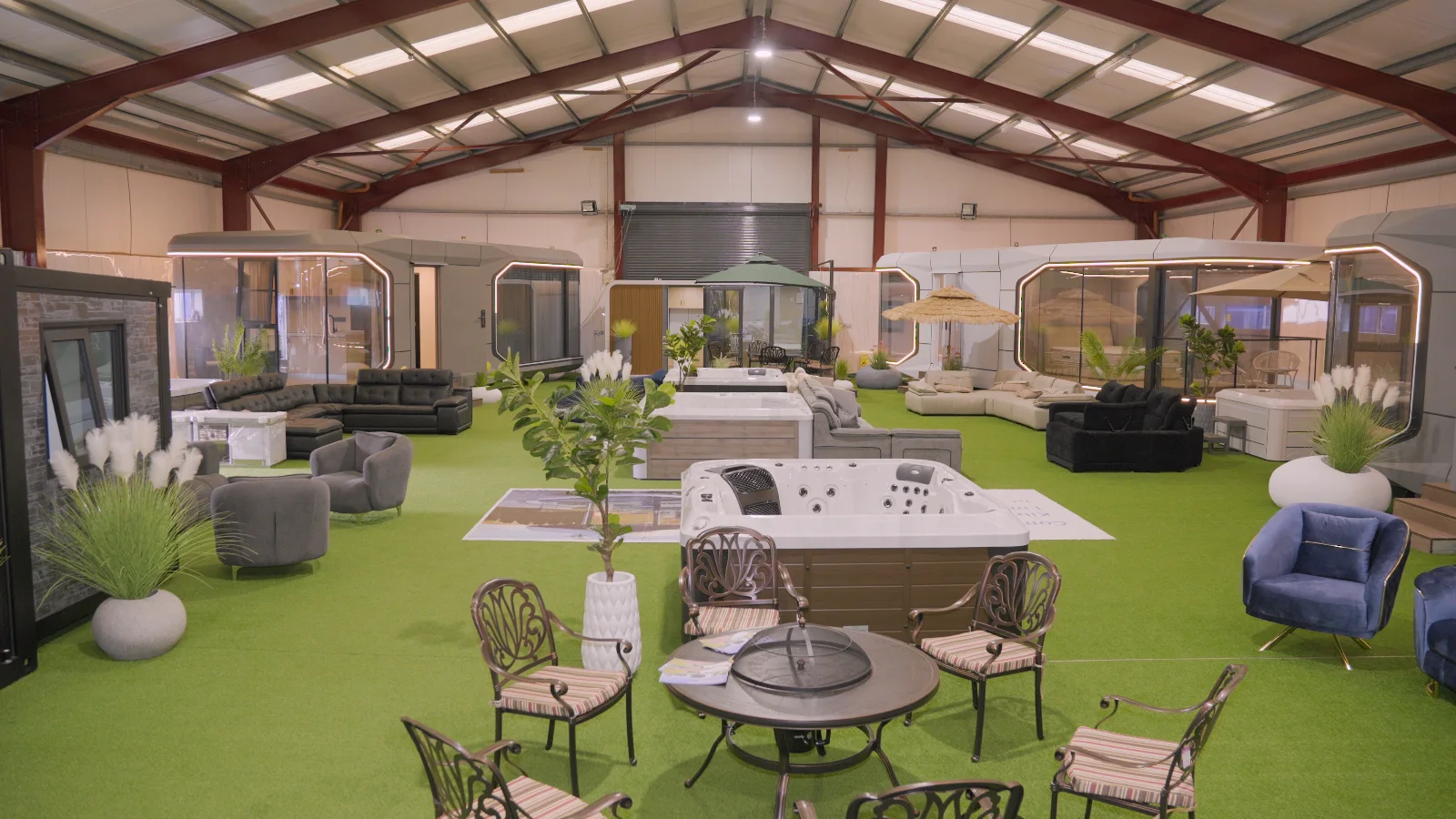 The Kilrush Ventures showroom floor in Ennis, pod homes ranged around hot tubs and furniture