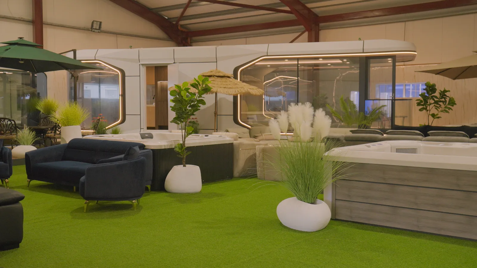 The Kilrush Ventures showroom floor, pod homes ranged on green turf